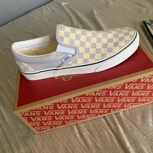 Slip-on checkered vans.